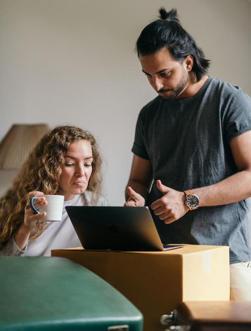 Couple in a house using a small notebook